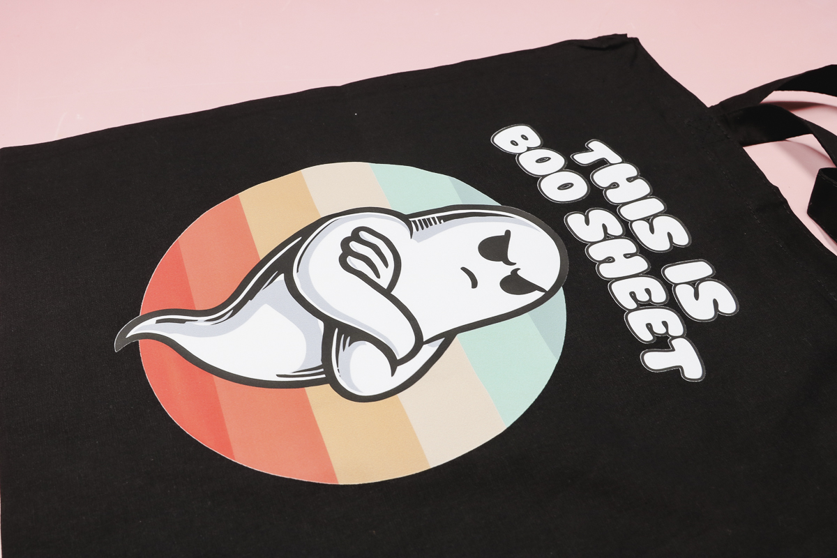 Ghost with rainbow background on black tote.