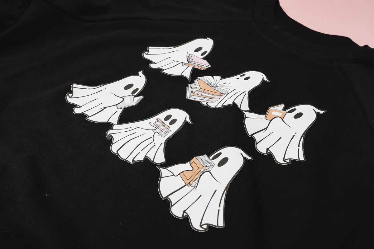 Ghosts reading books Glow in the Dark DTF in the light.