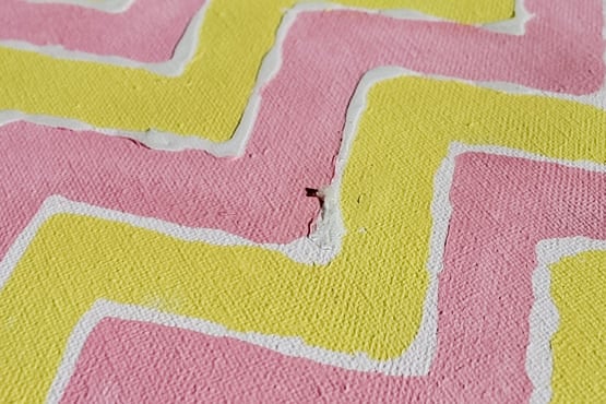 Removing glue from a painted canvas