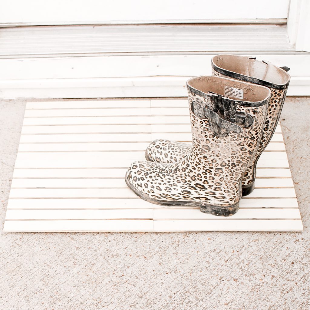 Wood door mat in front of a door