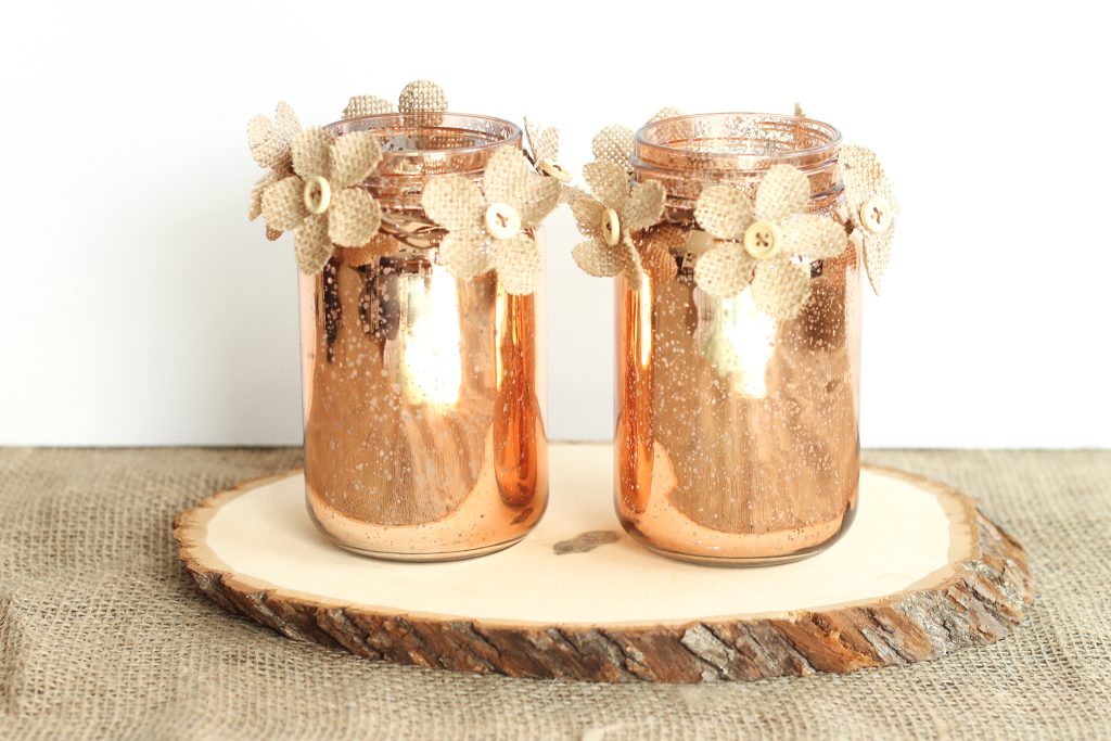 Copper jars sitting on a wood slice