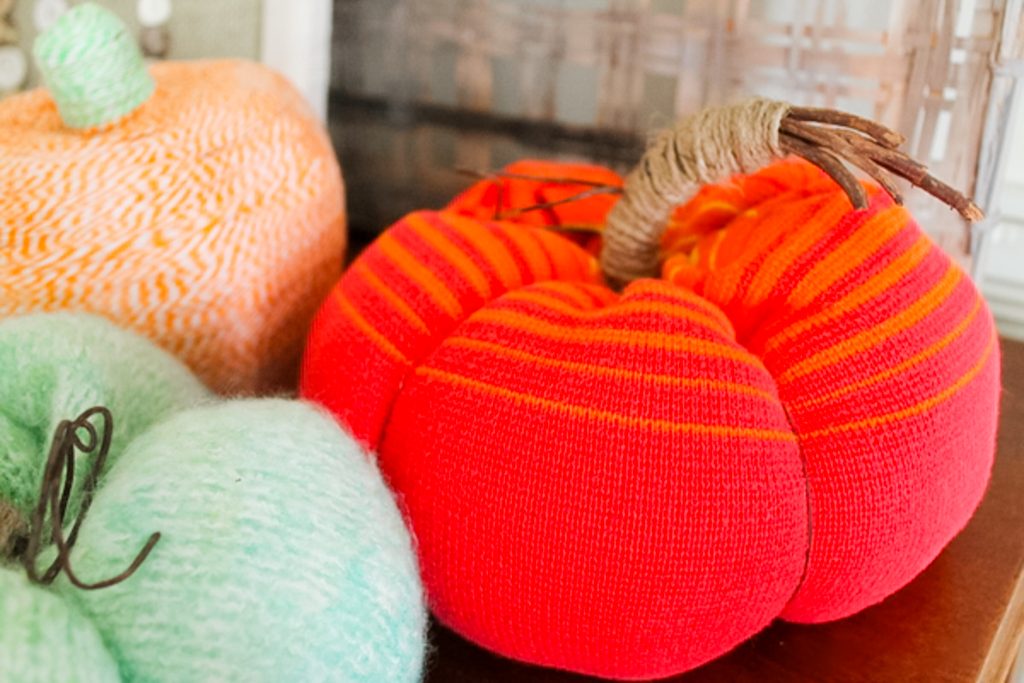 three fabric pumpkins on table