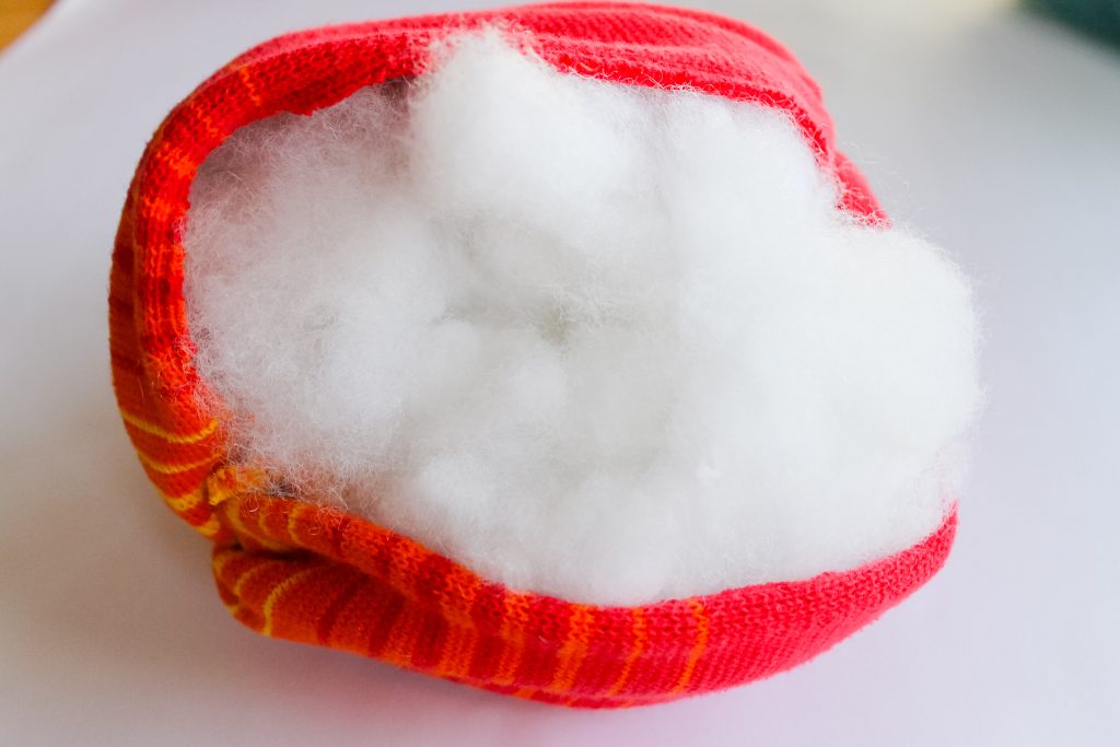 adding stuffing to fabric roll