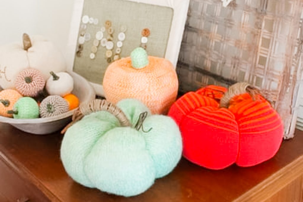 sweater pumpkins on wooden surface