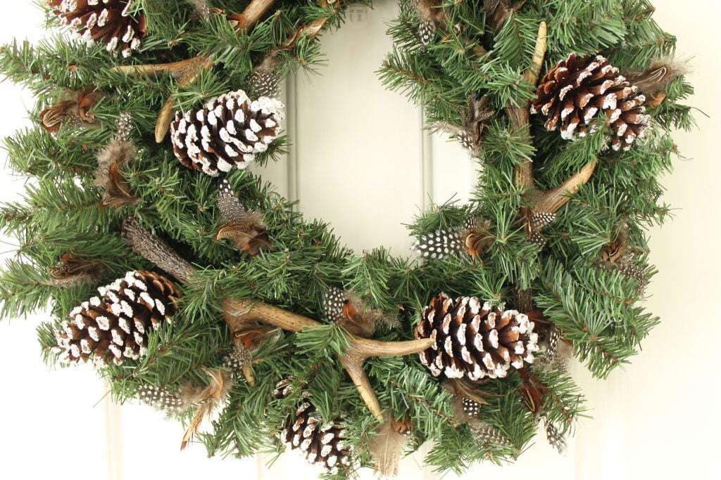 pincones, feathers and antlers on a wreath