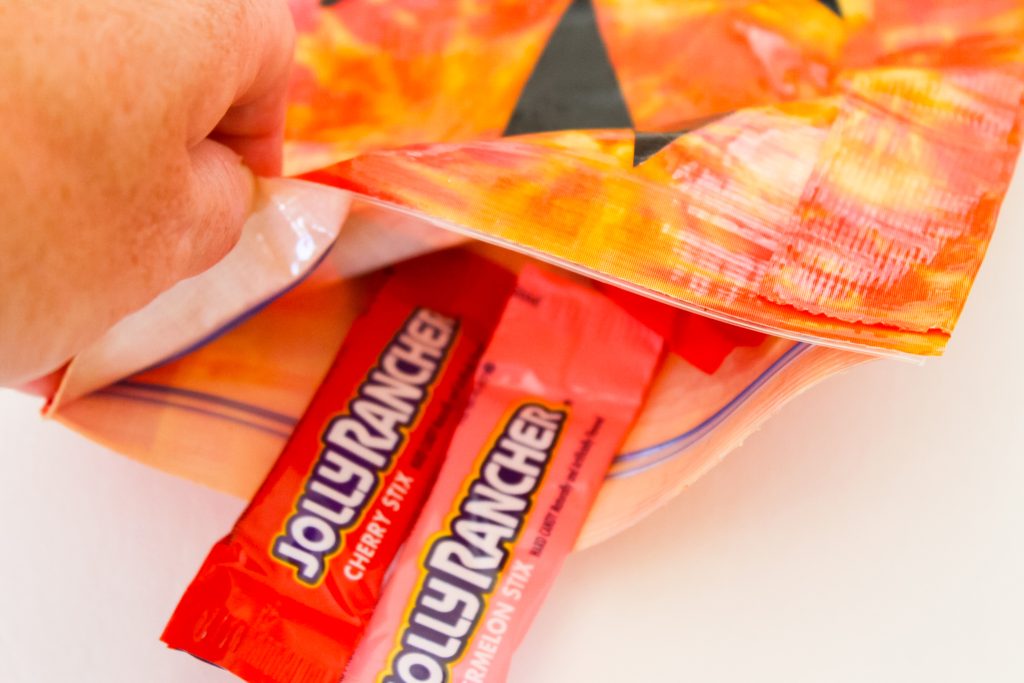 adding candy to treat bags