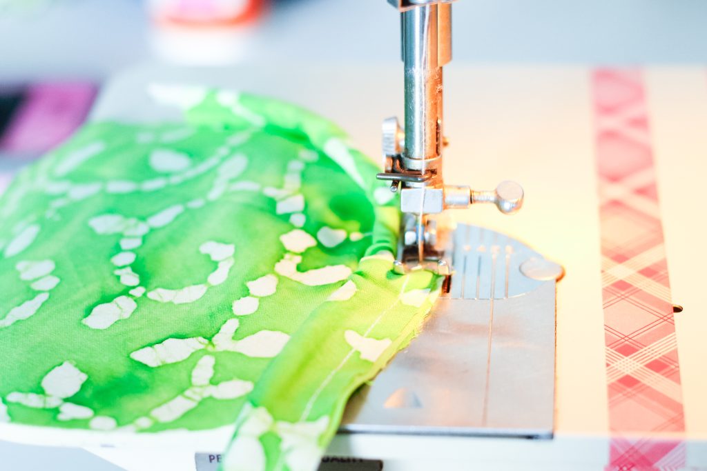 Sewing fabric covered cord to pillow end