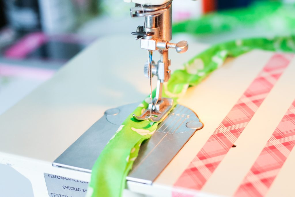 Sewing fabric around cording