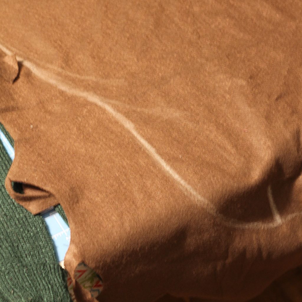 chalk outline on brown felt