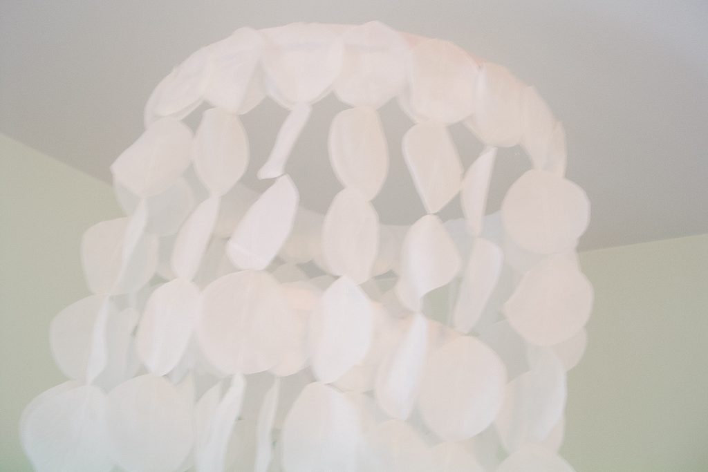 Close up shot of rose petals sewn into a chandelier