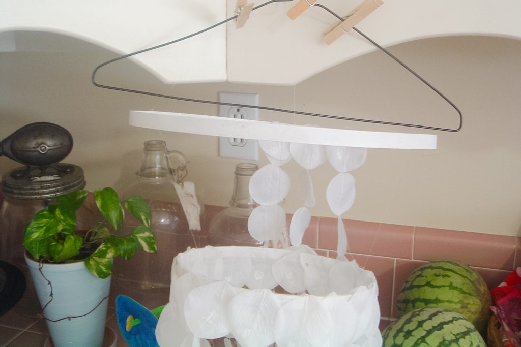 Attaching rose petals to the painted hoops