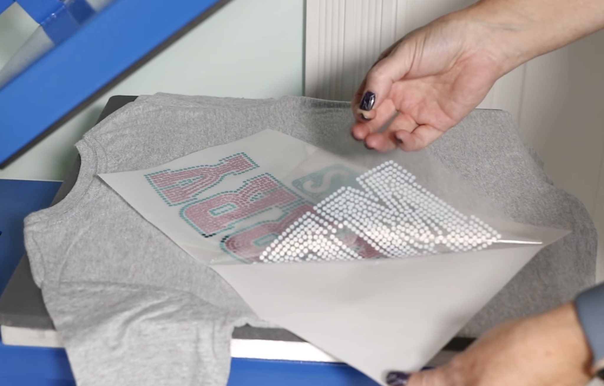 Remove backer from DTF transfer.