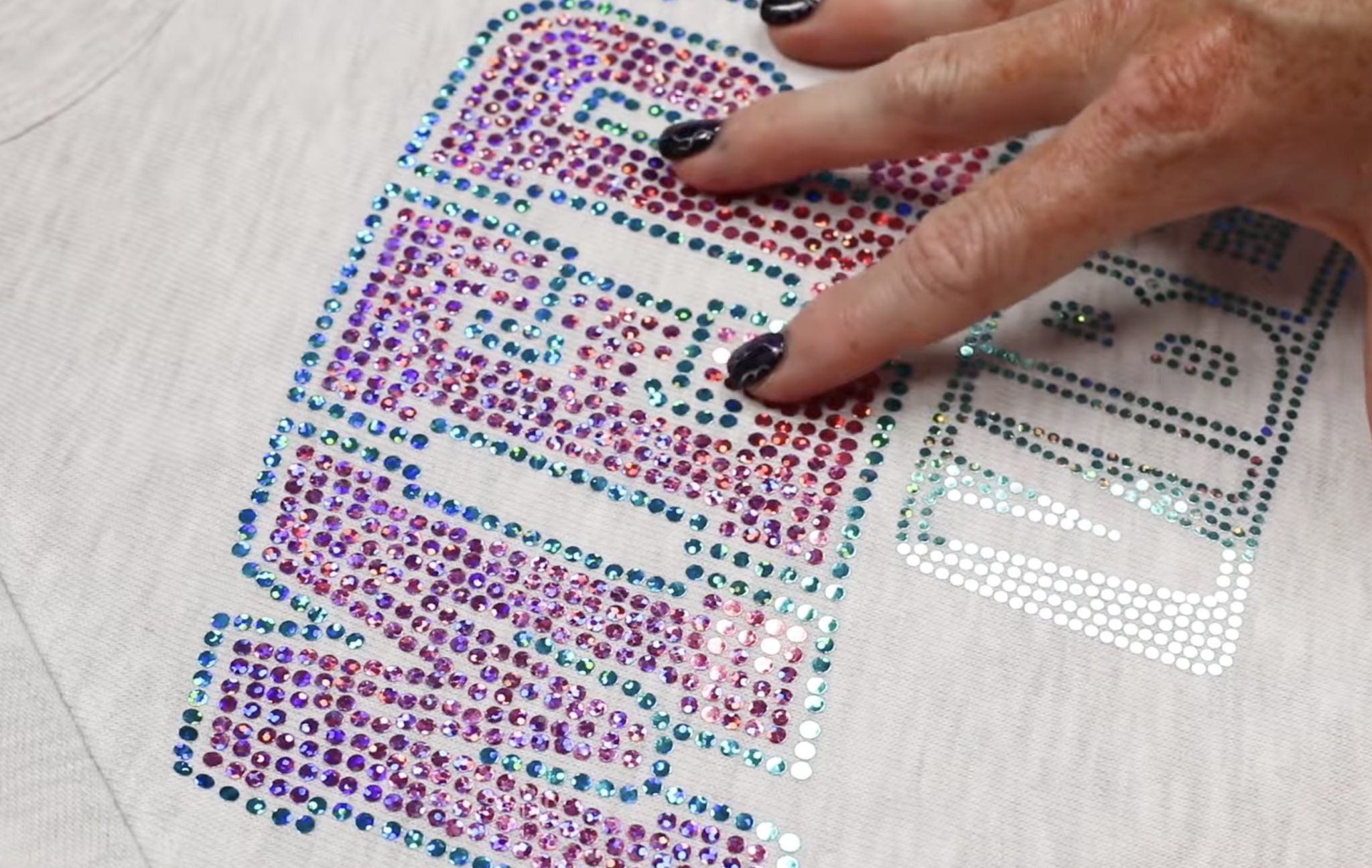 Close up of Spangle DTF on light colored sweatshirt.