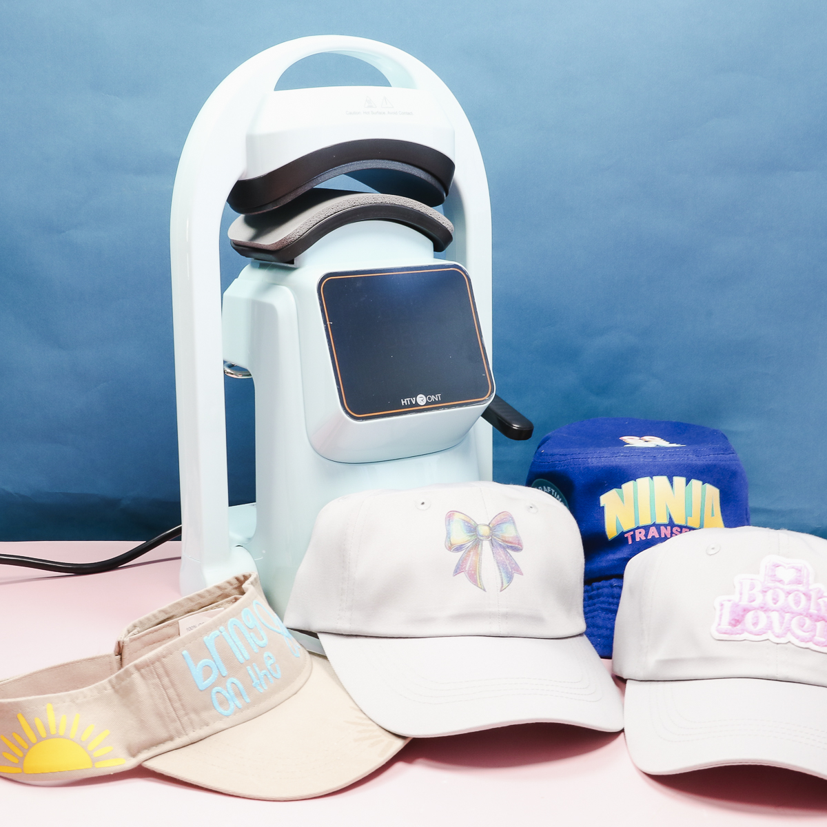 HTVRont auto hat press with finished hats.