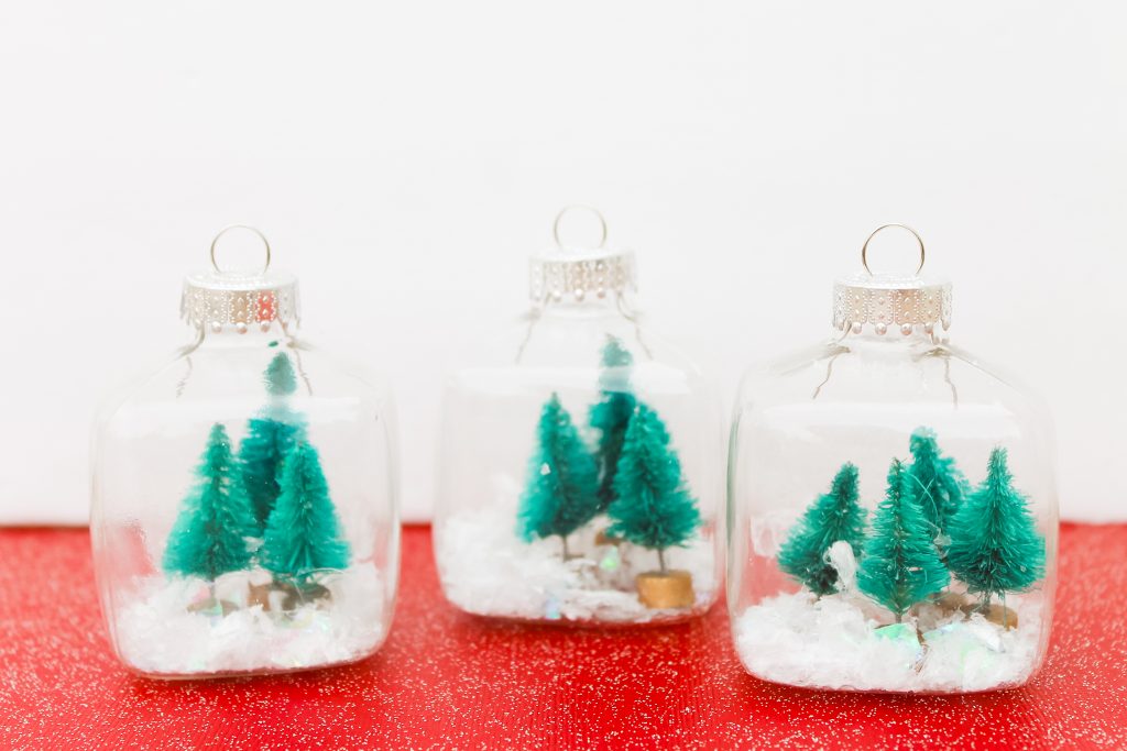 Kids Craft: Mini Snow Globe Ornaments -- click the picture to get the full instructions for making your own fun Christmas ornaments. glass ornaments with mini trees and glitter snow