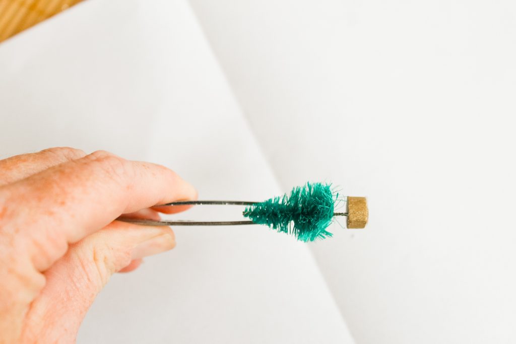 Kids Craft: Mini Snow Globe Ornaments -- click the picture to get the full instructions for making your own fun Christmas ornaments. Using tweezers to place mini trees in an ornament