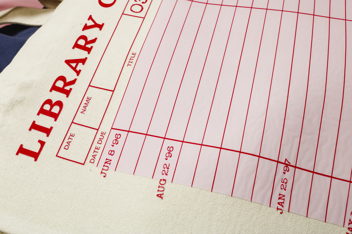 Tote bag with library card design.