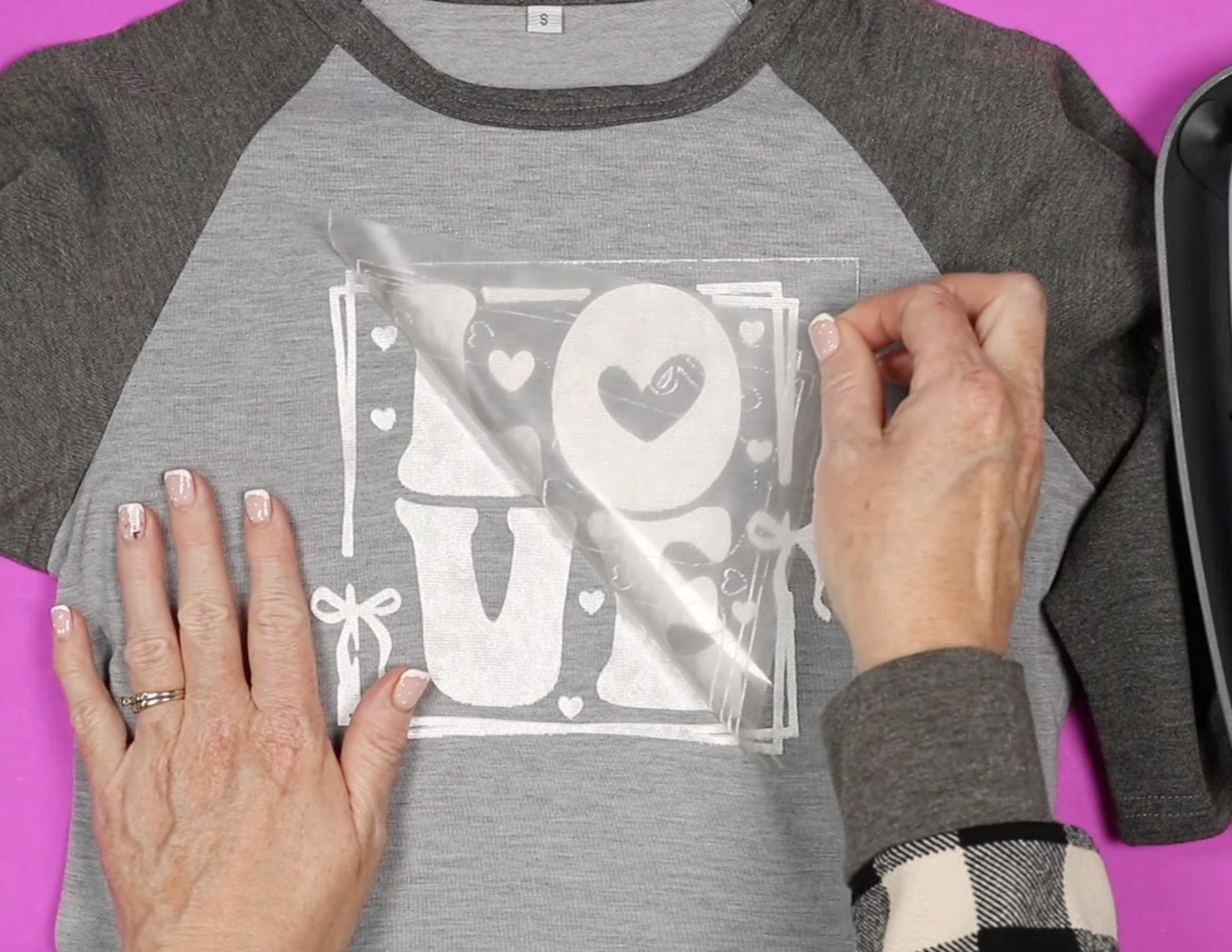 peeling the carrier sheet away from lush htv