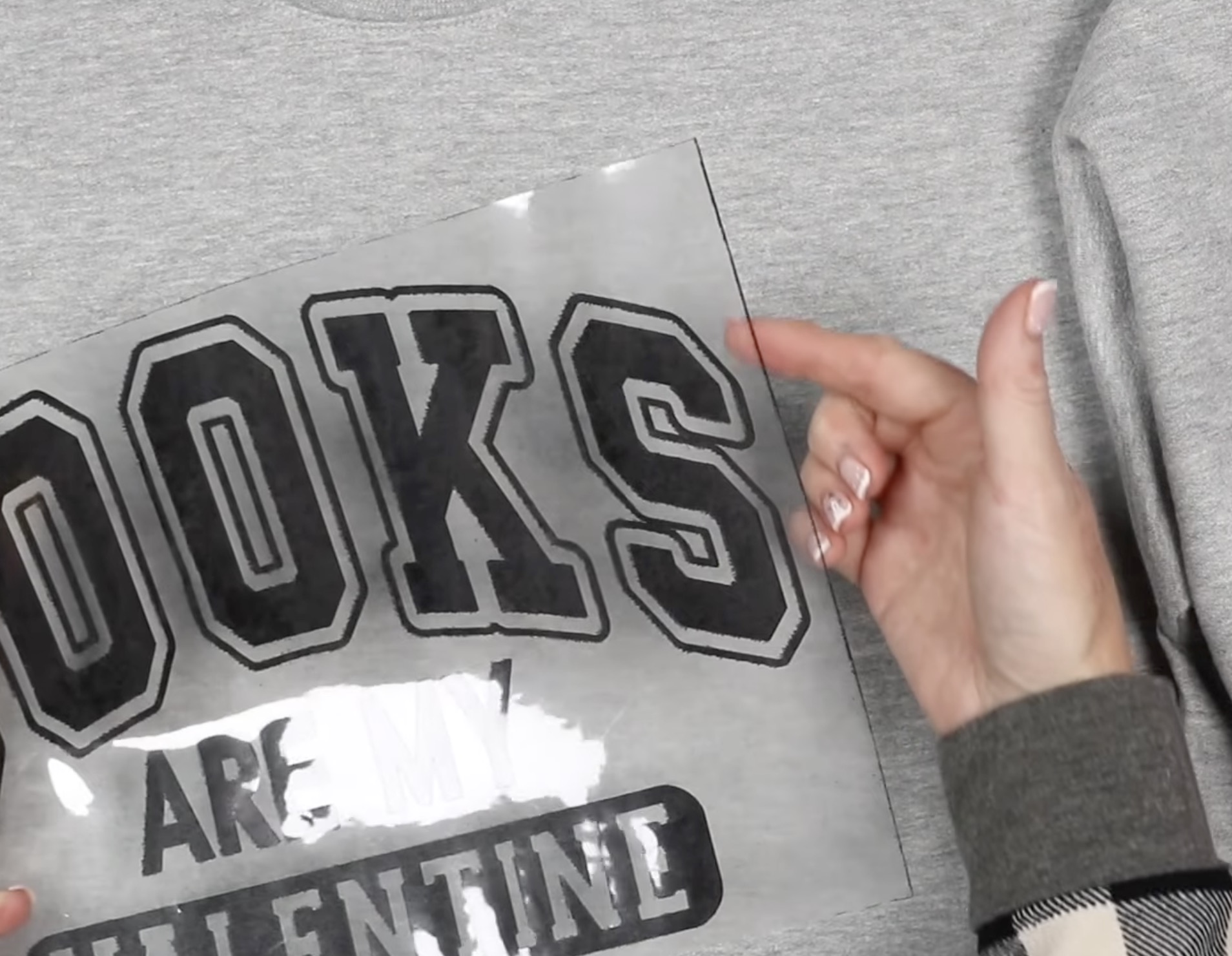 Close up of black fibers on edge of carrier sheet.