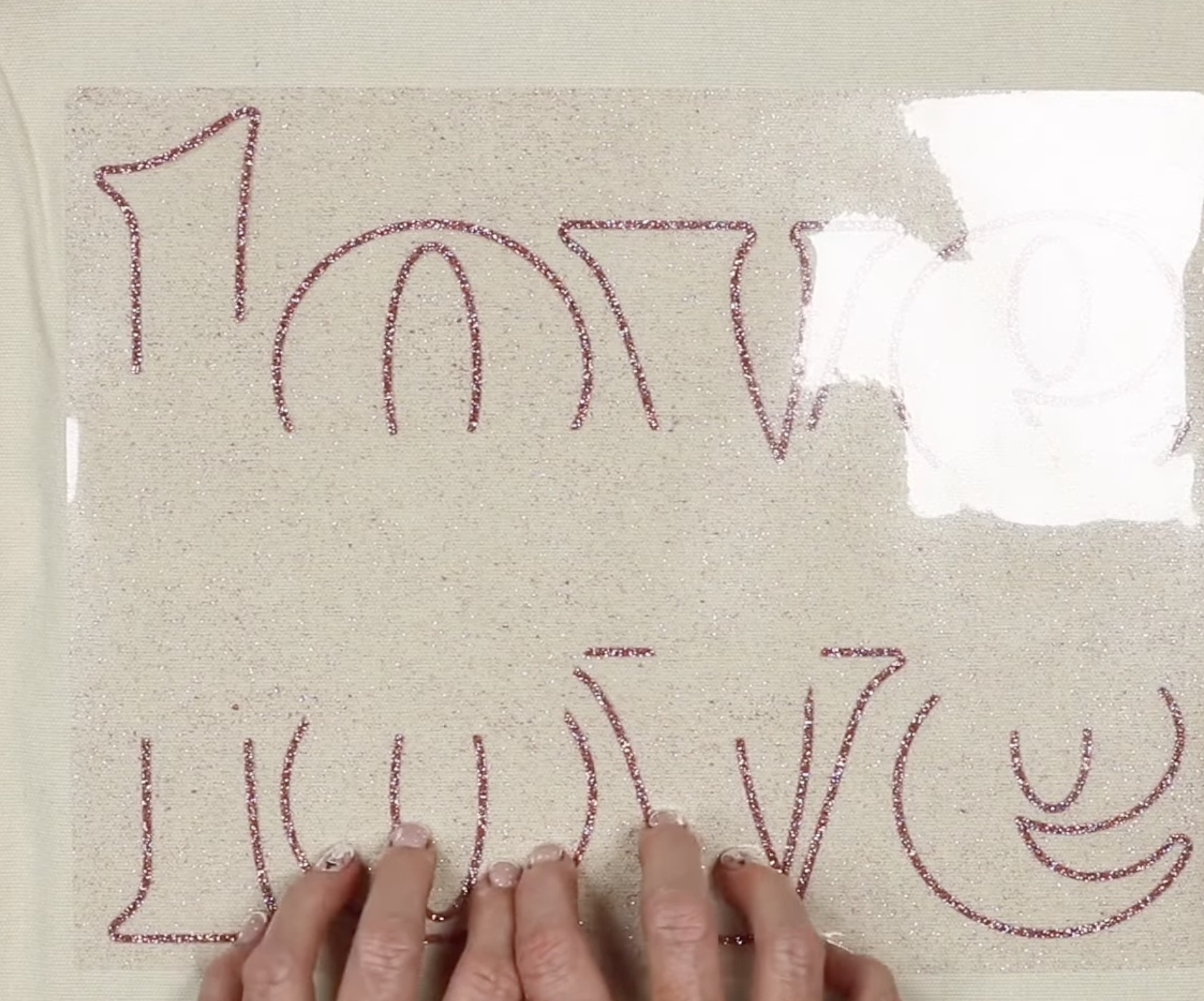 glitter htv being added to a tote bag