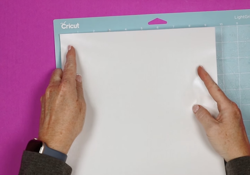 Place material shiny side down on the mat.