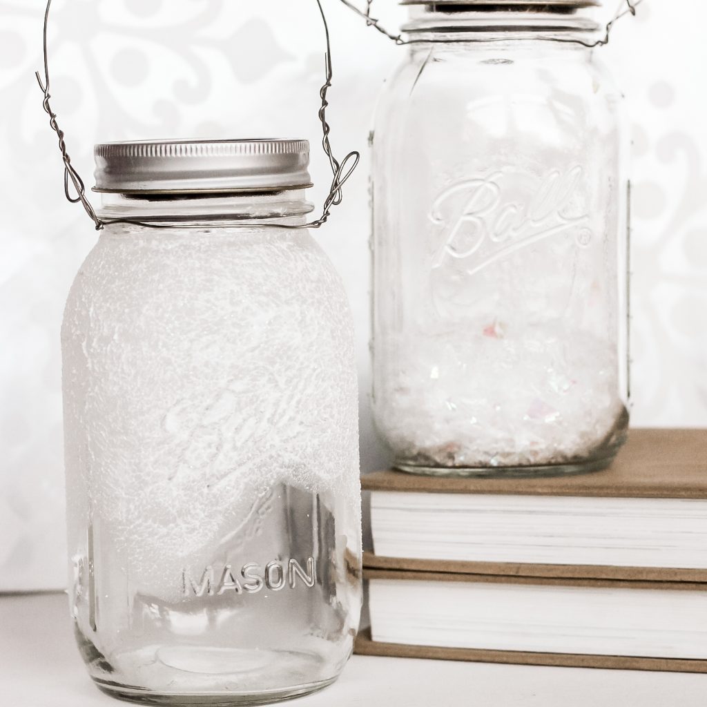 Jars with paint and with fake snow to make solar lights