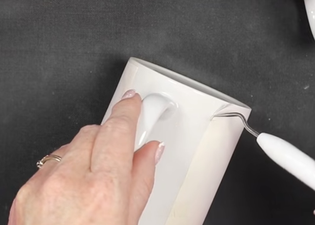 Use weeding tool to remove tape from hot mug.