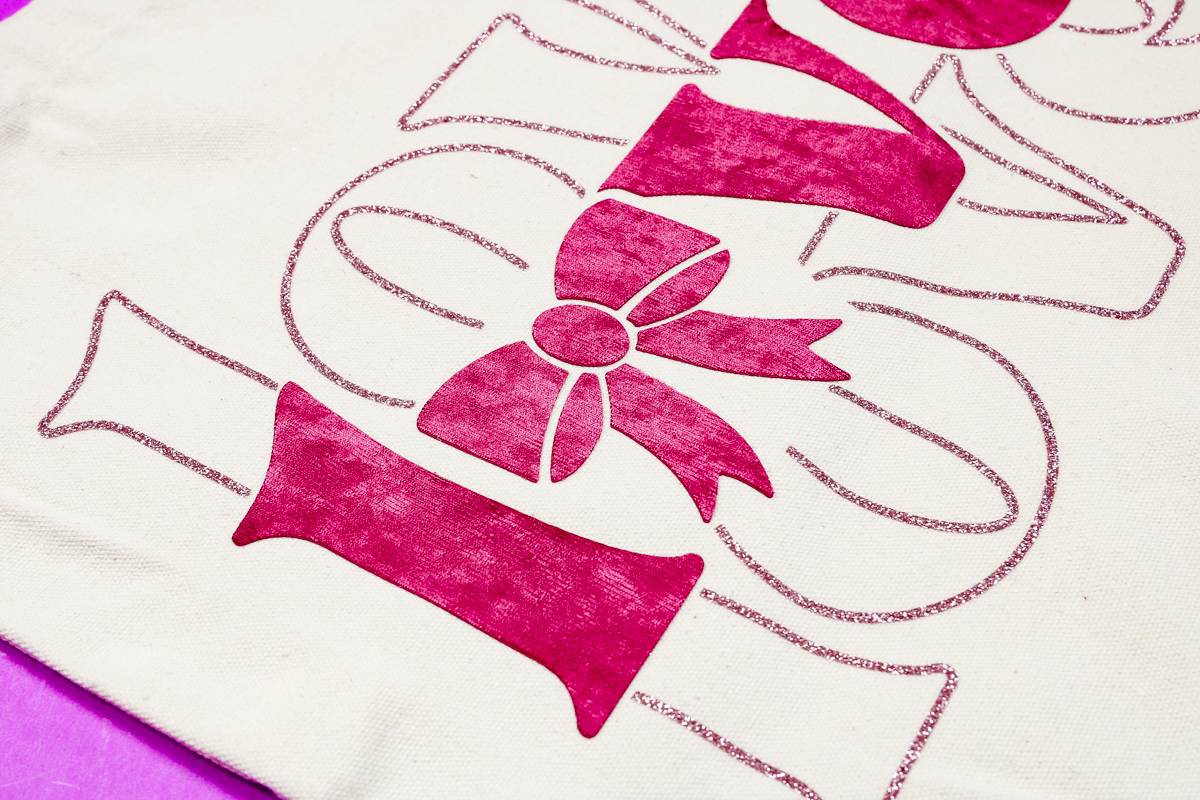 Close up of Lush HTV with glitter on a tote.