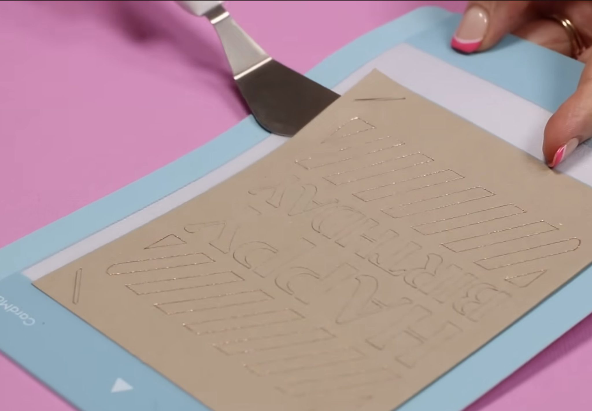 Use spatula to remove card from card mat.