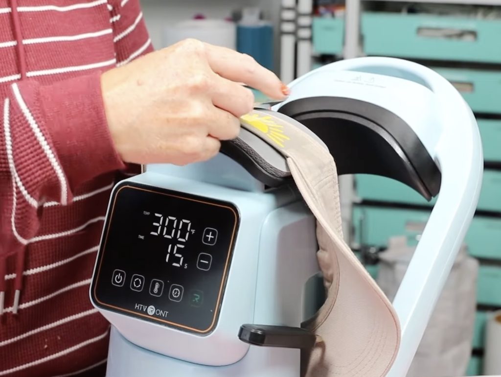 peeling back carrier sheet from htv on the side of the hat