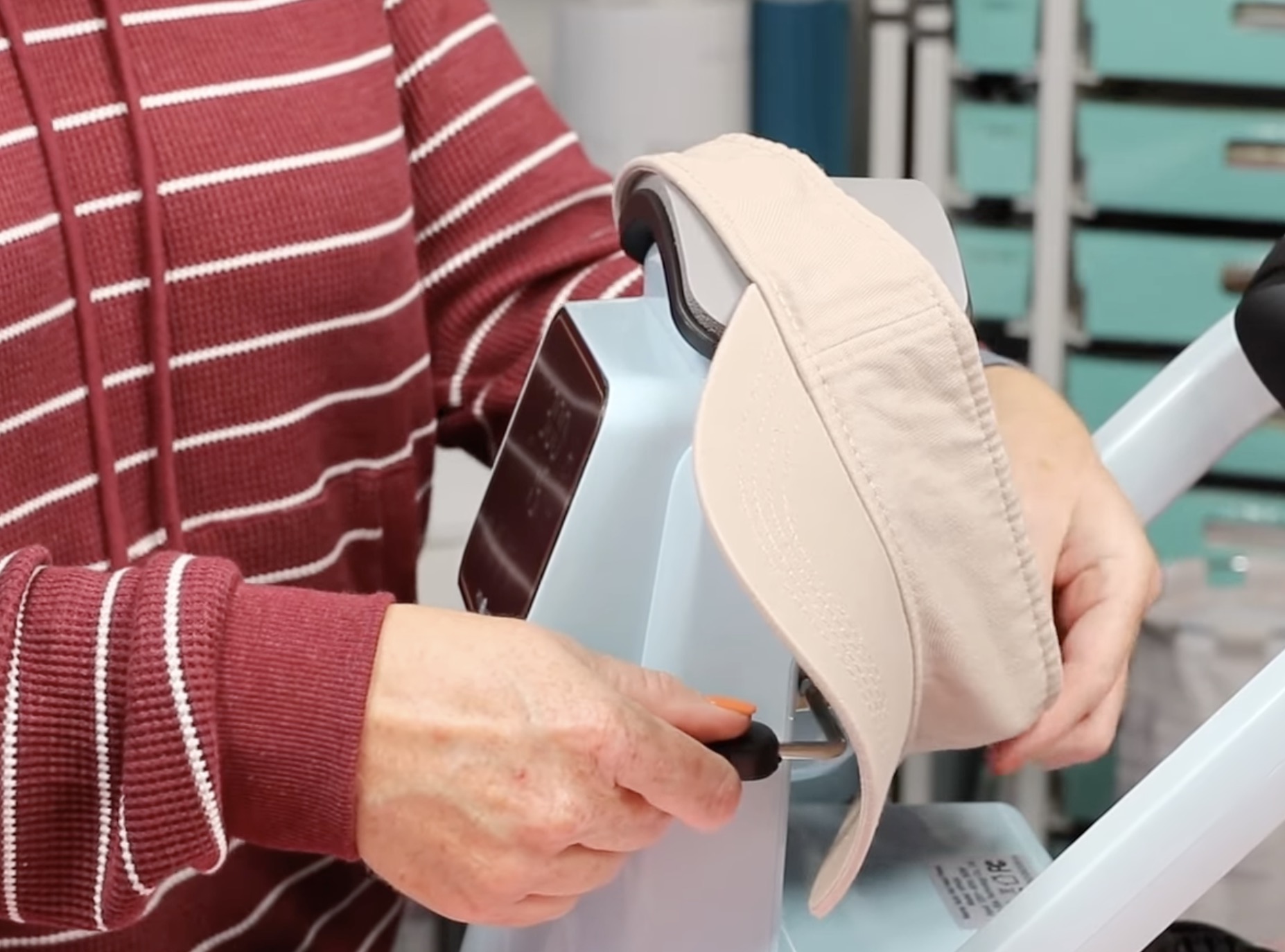 Visor on the hat press with bill to the side.
