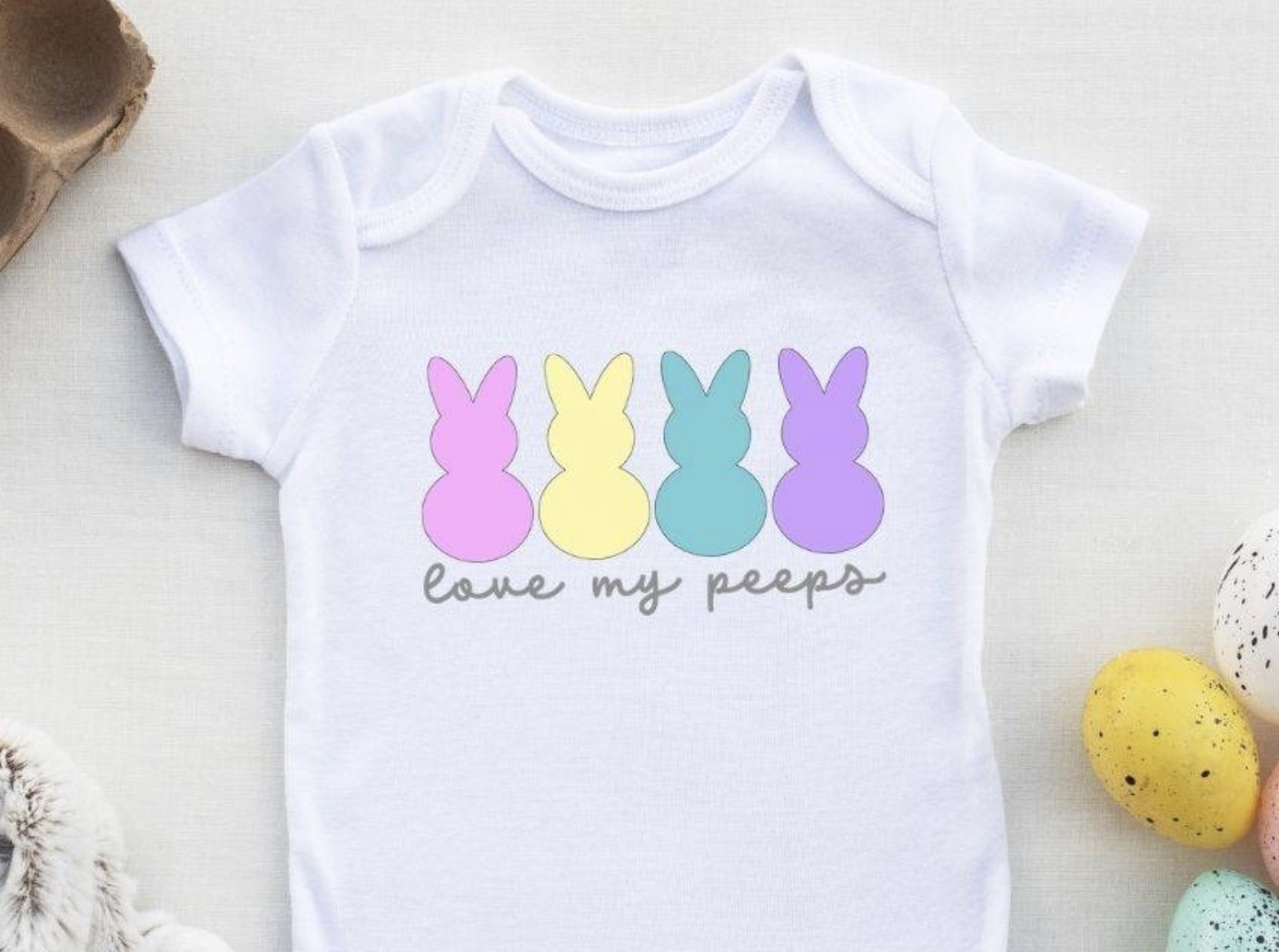 Baby onesie with colorful peeps.