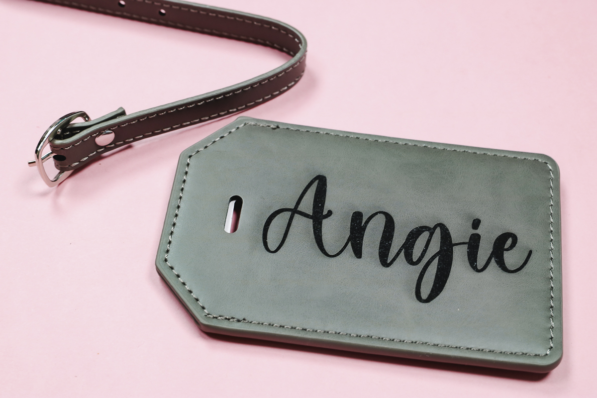 Laser engraved faux leather luggage tag.