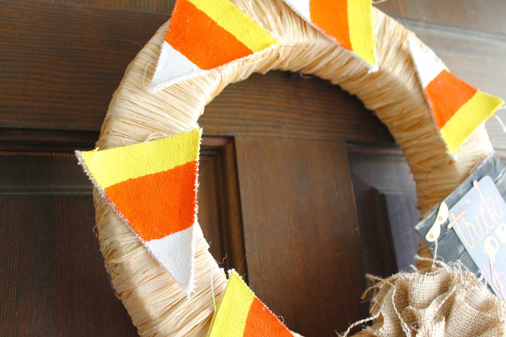painted triangles attached to raffia covered wreath