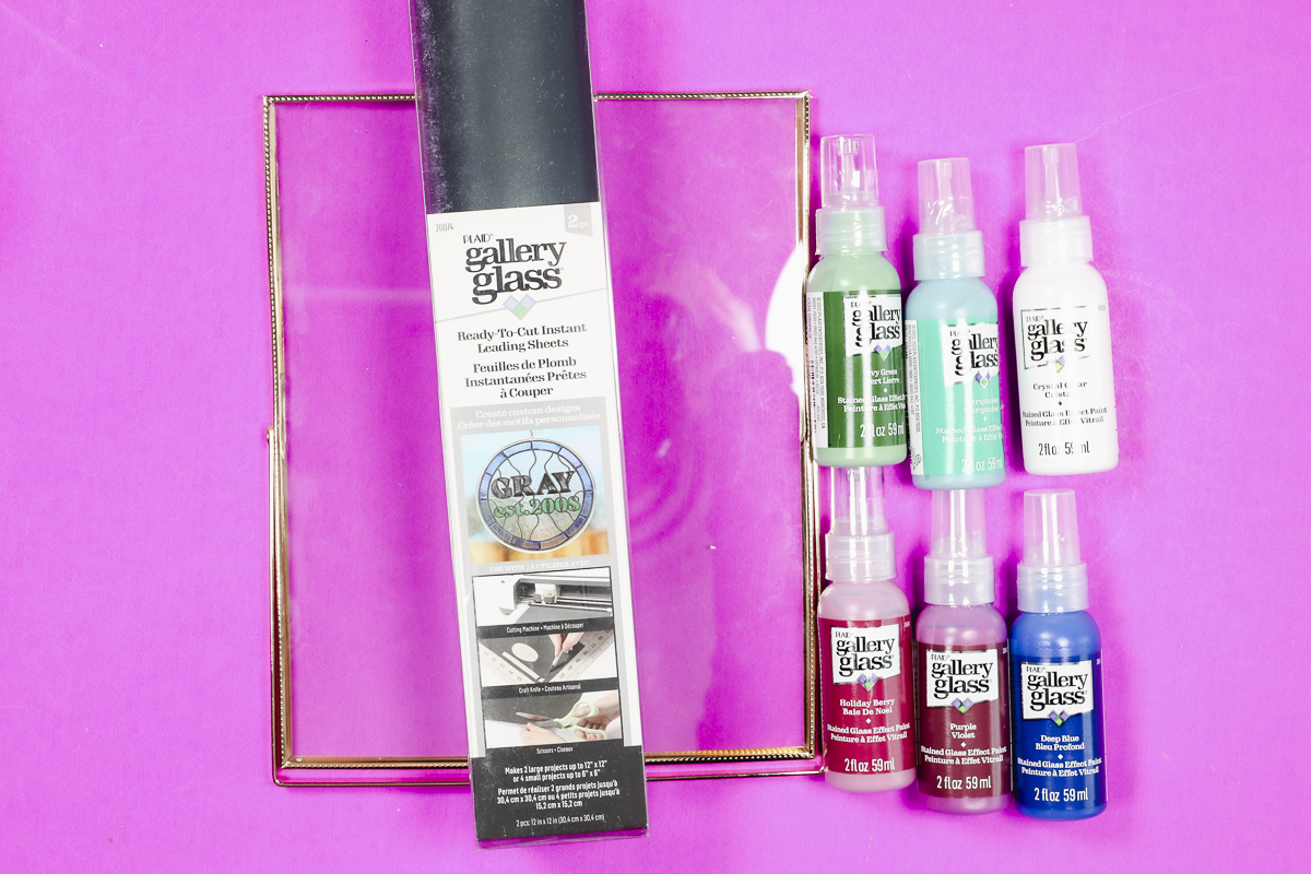 Supplies used to create faux stained glass with a Cricut machine.