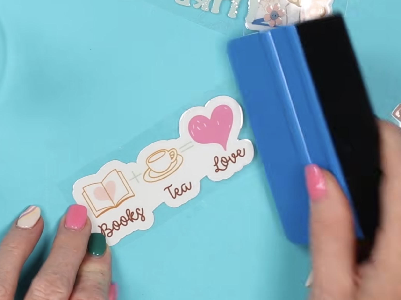 Rub sticker with scraper.