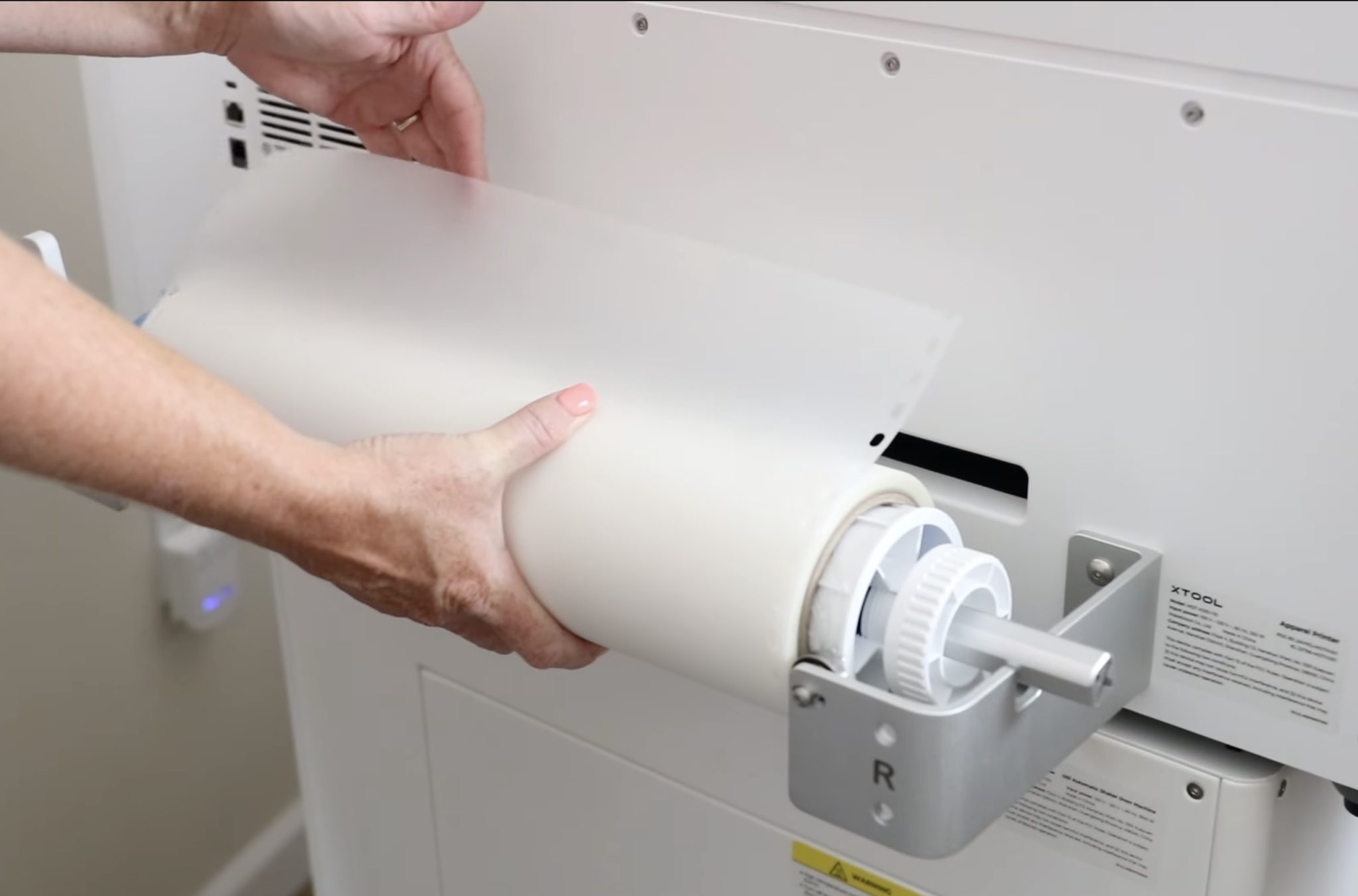 Add film roll to bracket.