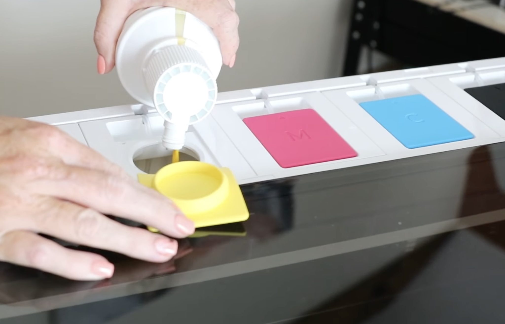 Pour the ink into the matching tank.