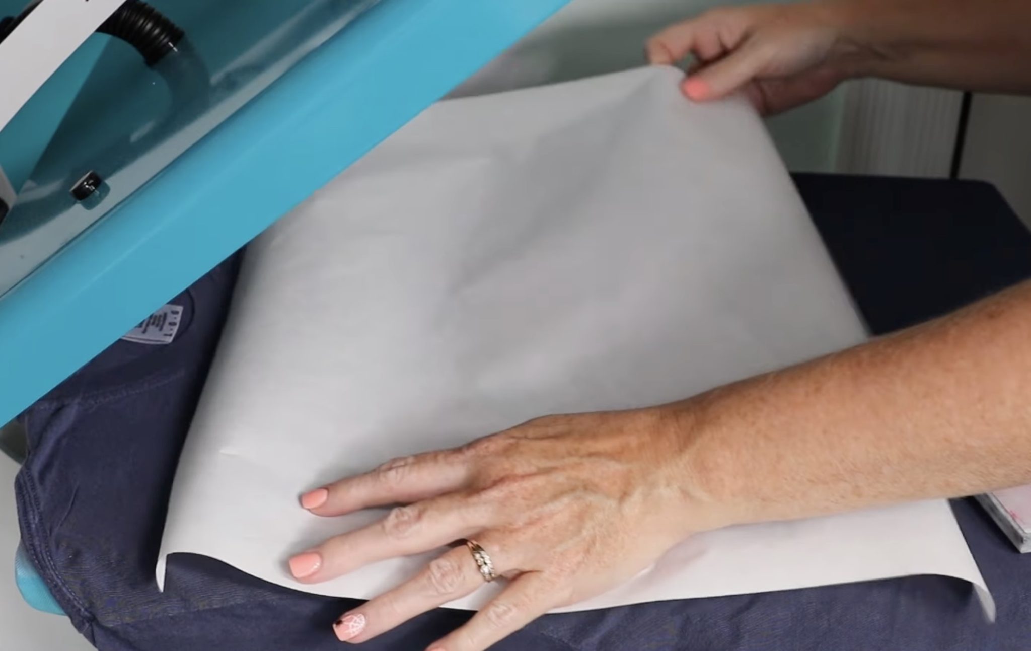 Place parchment paper over DTF design.