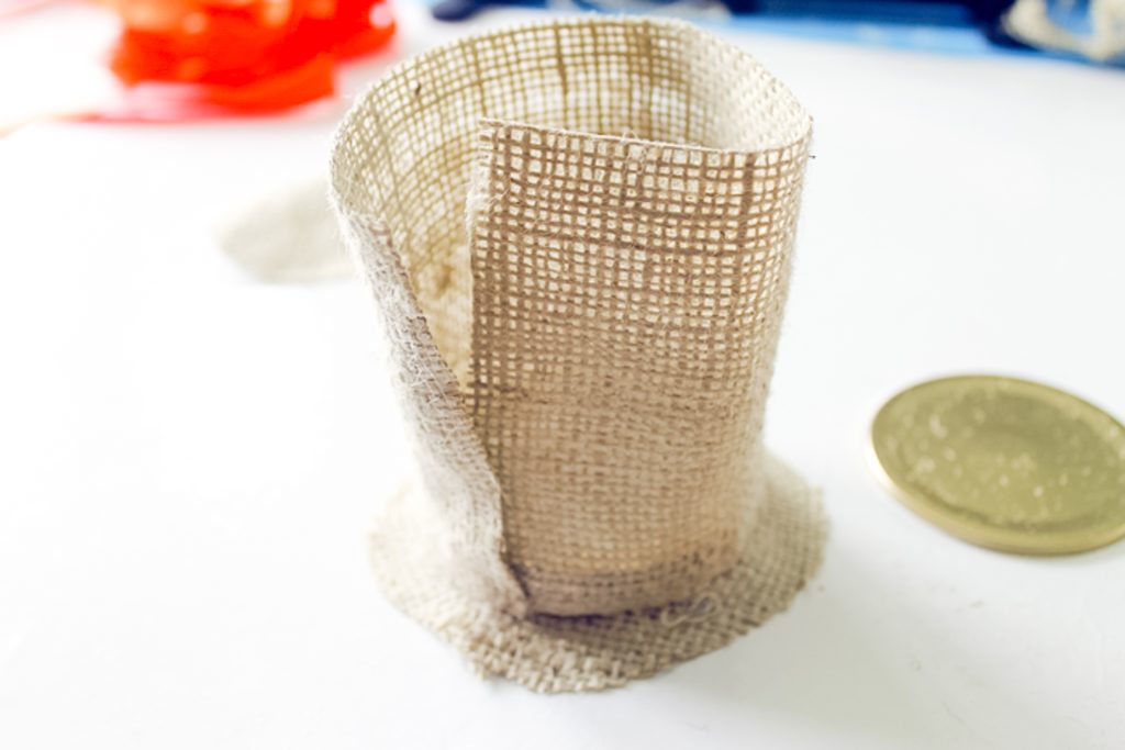 adding glue to a piece of burlap