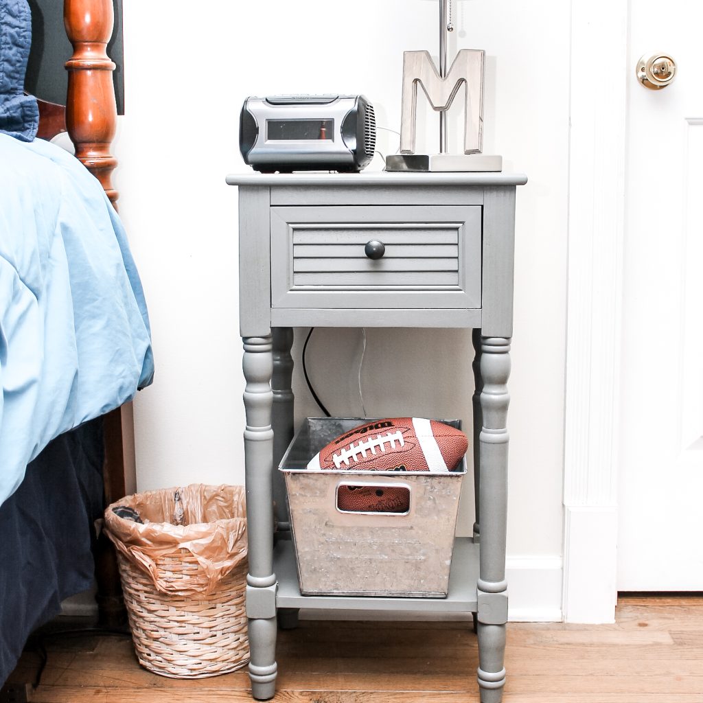 nightstand with a lamp and storage