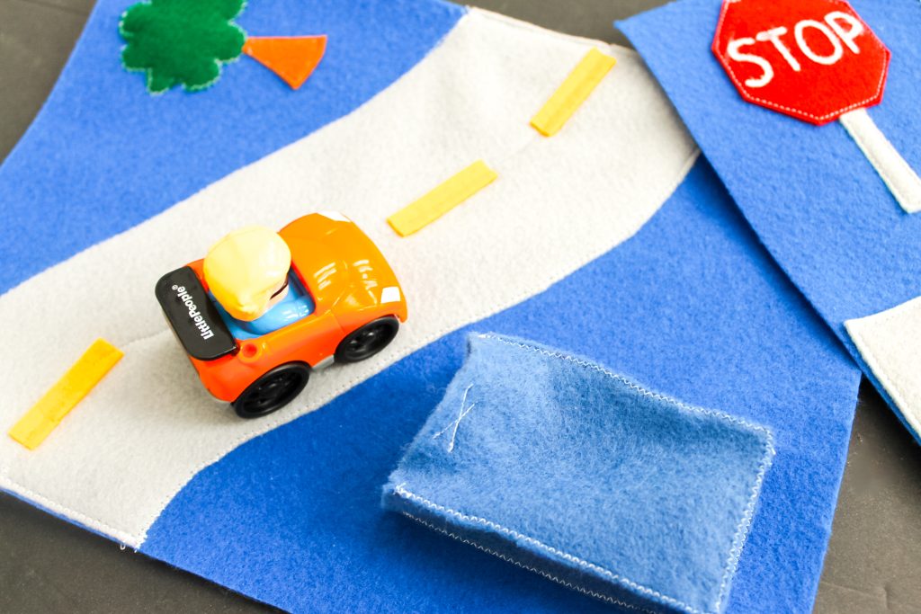 using the busy book with a toy car