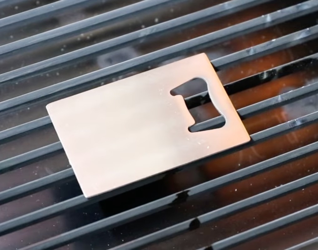 Add metal bottle opener to the laser bed.