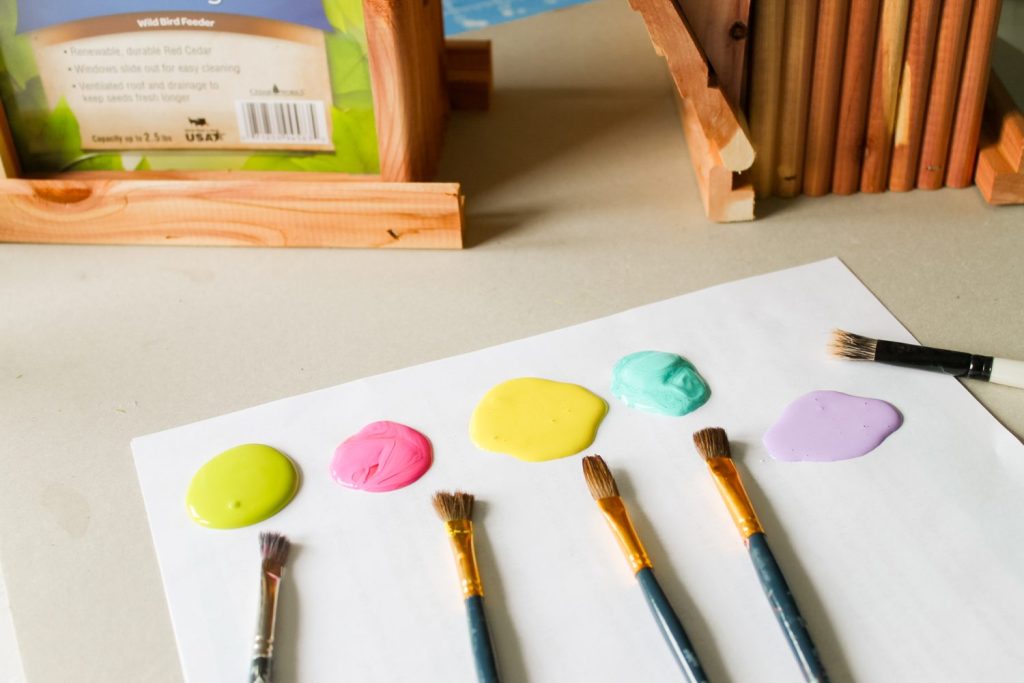 paint and paintbrushes on a piece of paper