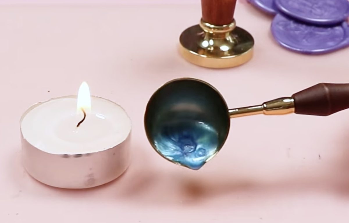 Pour the wax out of the brass cup.
