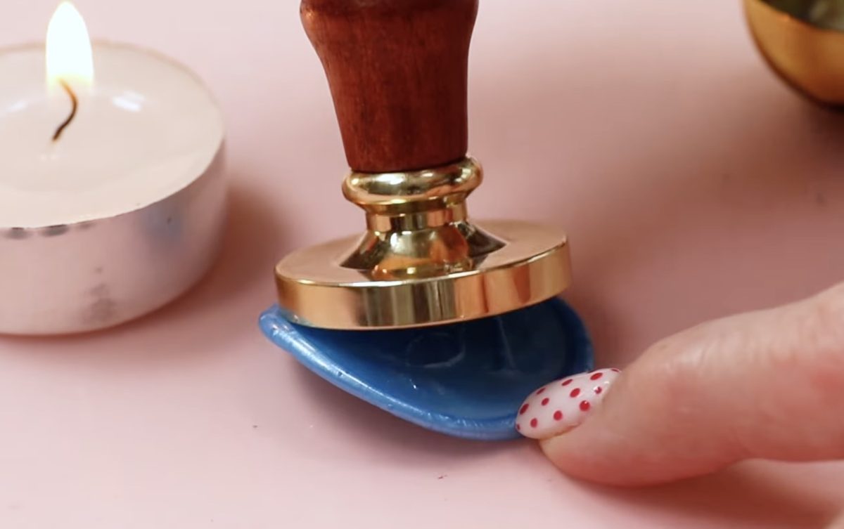 Remove the custom wax stamp from the wax seal.