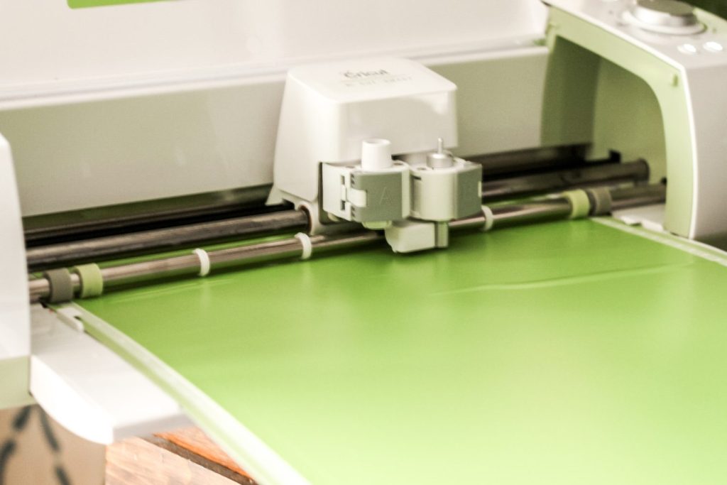 Cricut machine cutting a piece of vinyl