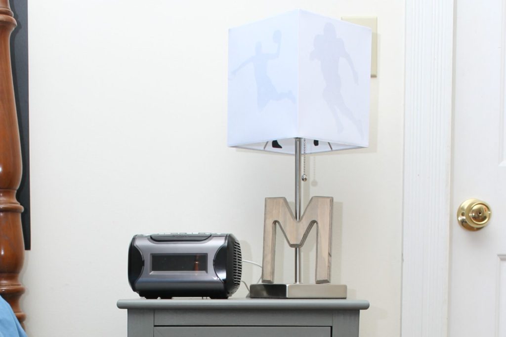 lamp and clock radio on a side table