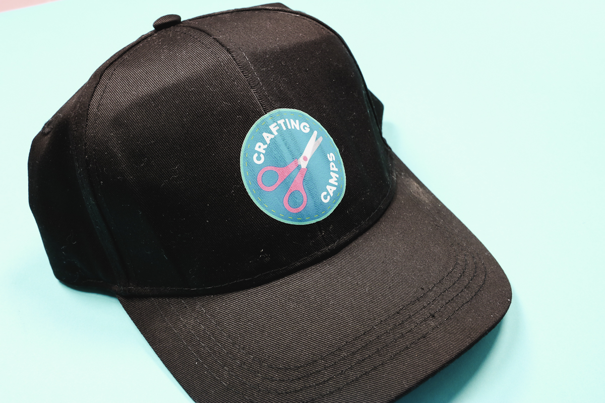DTF design on black hat.
