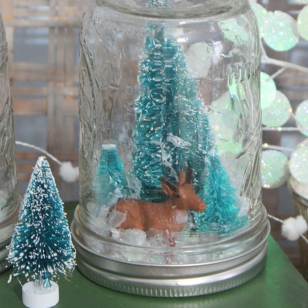 deer and tree in an upsidedown mason jar
